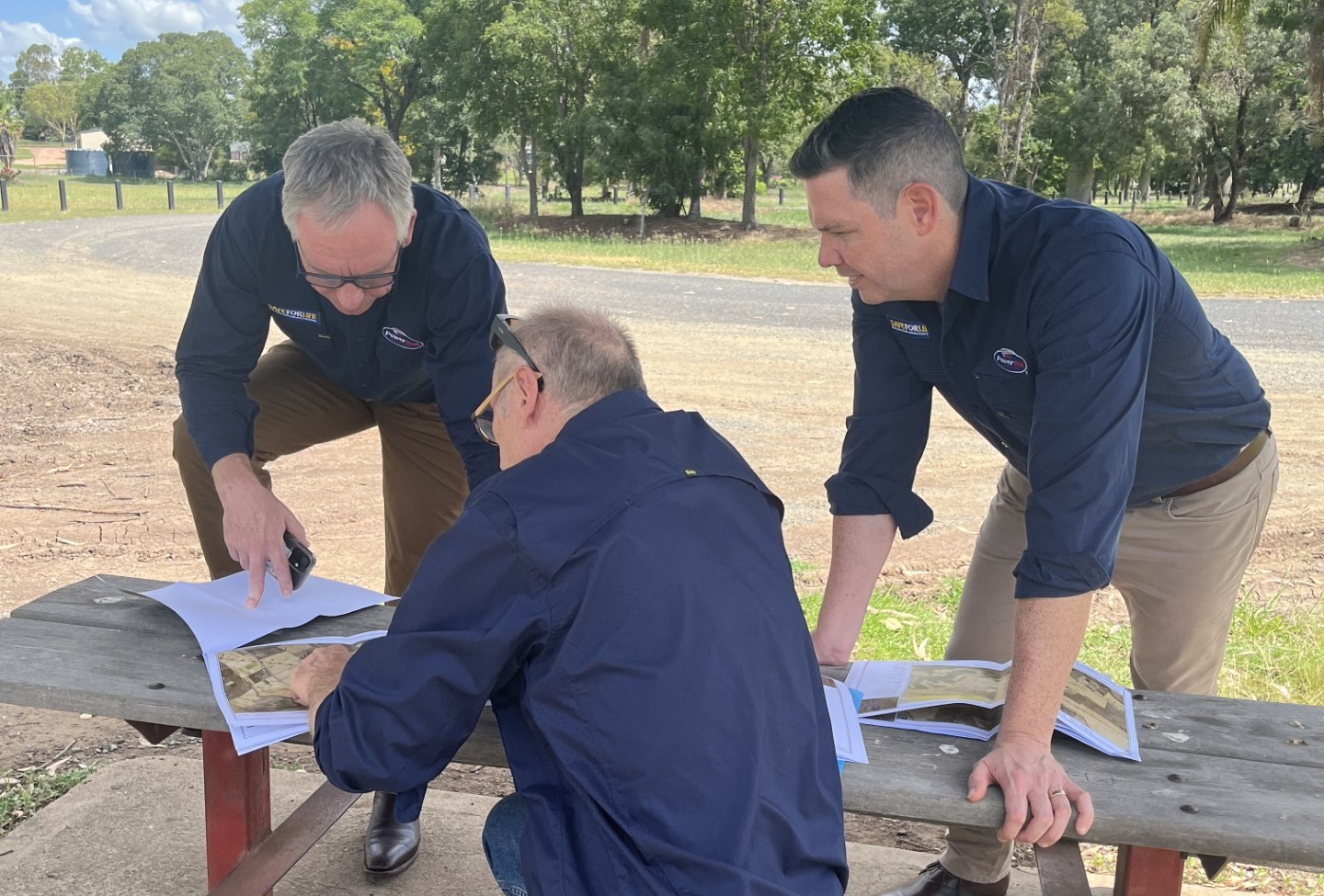 Powerlink staff looking at a map